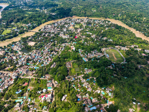 Aerial View of Bandarban Town with Curved Sangu River and Local Stadium Surrounded by Hills. Bandarban is a remote and mountainous district in southeastern Bangladesh known for its lush green hills.