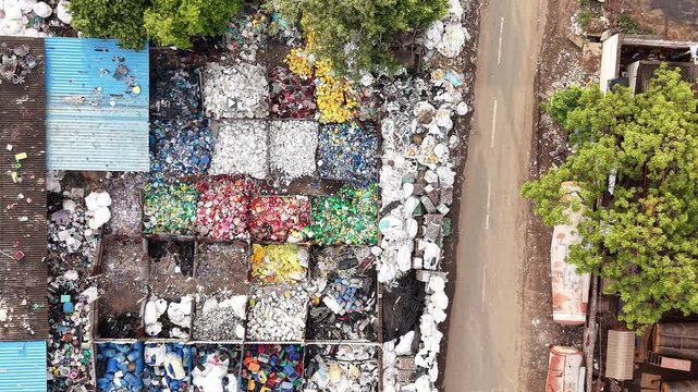 Segregated plastic waste bays at recycling yard aerial waste management circular economy recycling