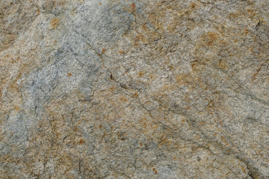 Grey natural stone texture background with golden ochre details