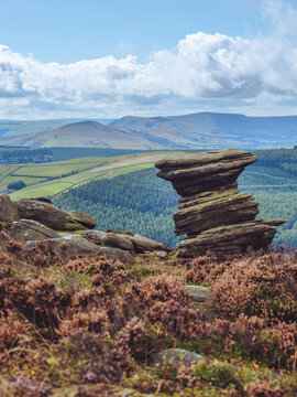 The 'Salt Cellar' grit stone wind weathered rock formation at Derwent Edge in the Peak District, with views over to Lose Hill and Mam Tor