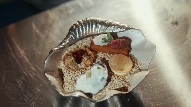 Artistic dessert arrangement presented in a silver seashell dish