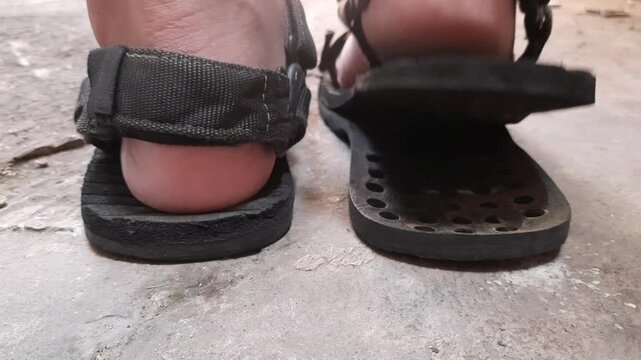 Person showing a damaged hiking sandal with sole detached due to aging glue, ideal for shoe adhesive commercial B-roll and emergency repair tutorials.