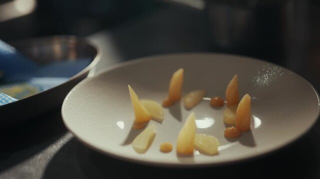 Close-up of peeled garlic cloves arranged on a white ceramic plate