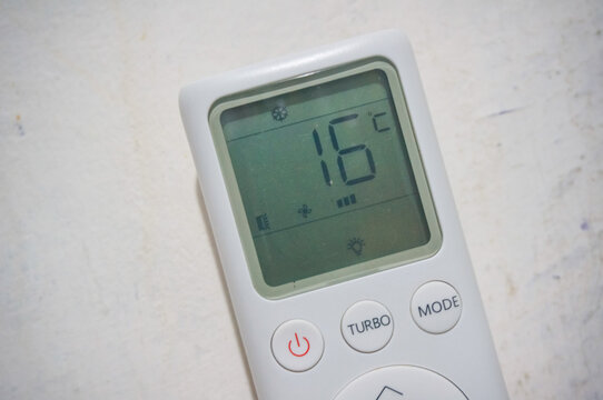 White air conditioner remote control display setting temperature to 16 degrees Celsius.