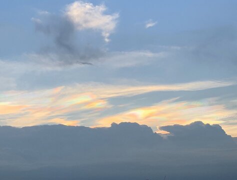 Iridescent cloud with rainbow colors at sunset