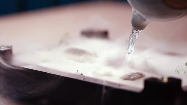 Liquid nitrogen creates dramatic effect over a chocolate dessert plate
