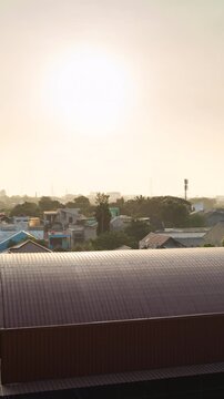 Vertical video - Timelapse of the sun setting behind Jakarta skyline and covered by heavy air pollution