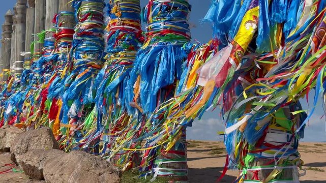 Lake Baikal. Video of sacred place on Olkhon Island, near Khuzhir. Tourists and Buddhists come to Cape Burkhan to tie colorful ribbons, blue Hadaks, and Buddhist prayer flags with mantras to 13 Serge