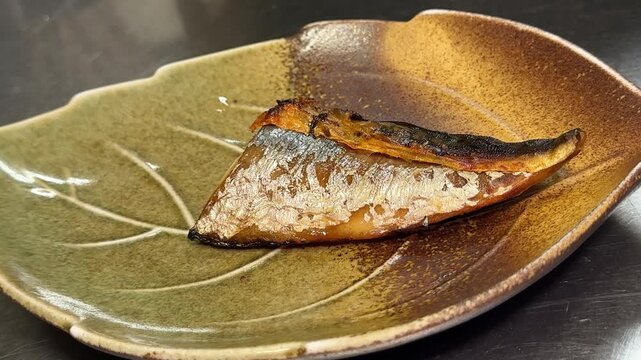 Grilled Mackerel Served on a Plate with Grated Daikon and Lemon: Salted Saba (Shioyaki), Traditional Japanese Food