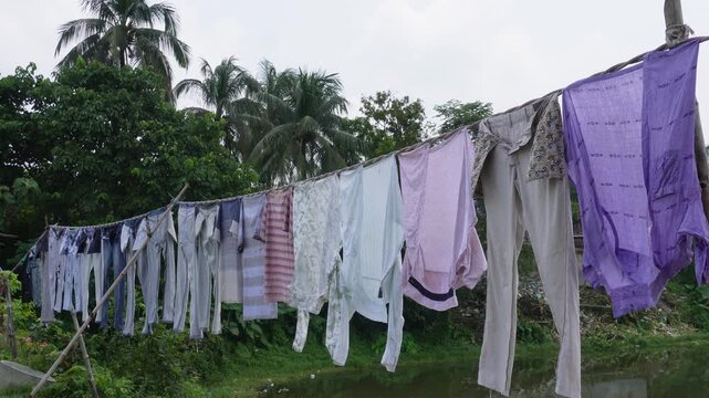clothes drying on a clothesline beside a rural pond