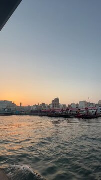 Traditional wooden abra boat crossing Dubai Creek in historic Old Dubai, UAE