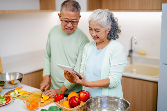 mature couple preparing food together at home