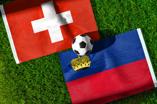 Switzerland vs. Liechtenstein football match. National flags on green grass with soccer ball in the middle. Football background for international match.