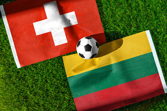 Switzerland vs. Lithuania football match. National flags on green grass with soccer ball in the middle. Football background for international match.