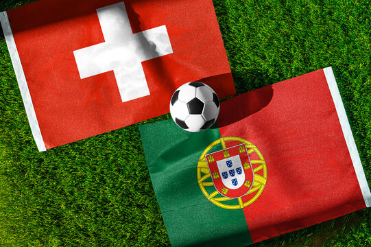 Switzerland vs. Portugal football match. National flags on green grass with soccer ball in the middle. Football background for international match.