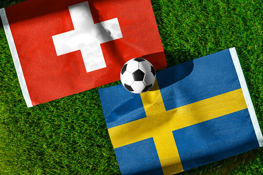 Switzerland vs. Sweden football match. National flags on green grass with soccer ball in the middle. Football background for international match.