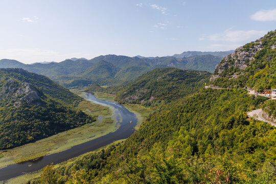 Winding river canyon with green mountains aerial view