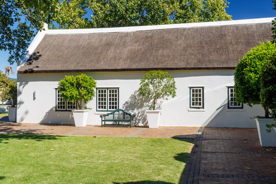 Cozy white house with thatched roof