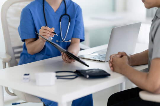 physician consults with a patient in a clinic for medical assessment