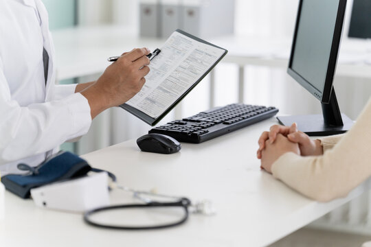 physician provides medical advice to a patient in a clinic consultation
