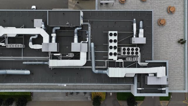 Aerial top view of industrial rooftop ventilation and HVAC duct system
