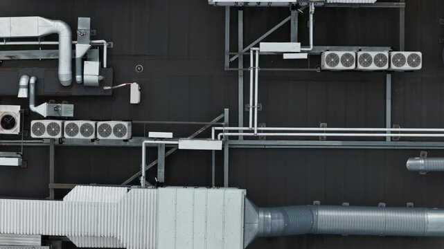 Aerial top view of industrial rooftop ventilation and HVAC duct system