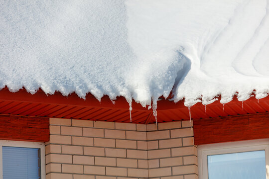Snow covers a red roof