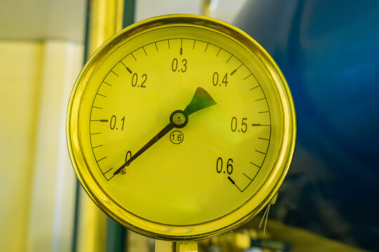 Close up of pressure gauge meter showing measurement scale in industrial equipment, monitoring system and engineering control concept.