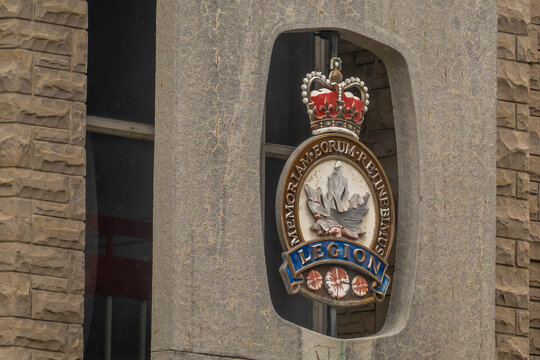 Ottawa, ON, Canada - Sept 15, 2026: Royal Canadian Legion crest mounted on a stone building exterior facade in close-up.
