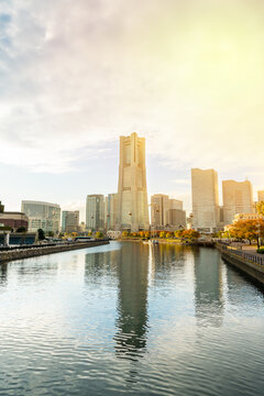 view of yokohama landmark tower and minato mirai city skyline, cityscape during golden hour sunset