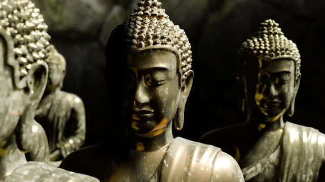 close up of traditional religious figure buddha metal bronze statues for praying in a temple,