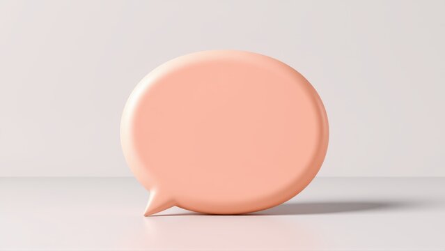 Peach speech bubble stands on surface. Minimalist design, soft lighting, simple studio shot. Clean background enhances object focus.