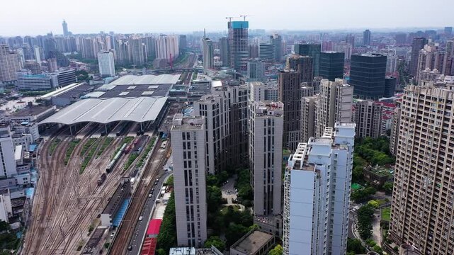 Aerial View of a Dense City with a Major Railway Station and Train Tracks