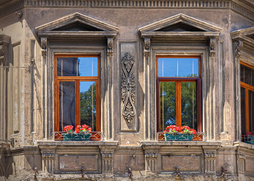 Old building facade featuring windows and flower boxes