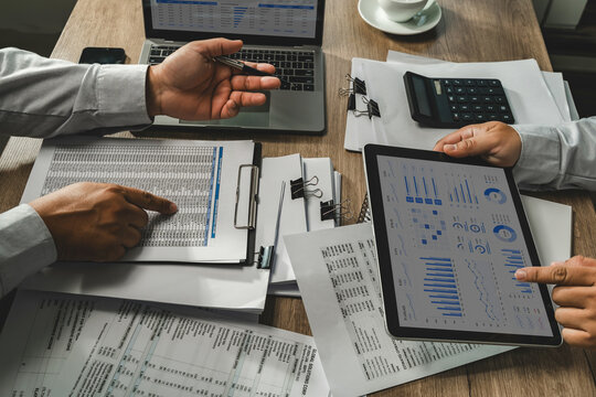 Business team reviewing accounting financial reports, calculator and tablet dashboard for business data analysis, financial review and reporting workflow.