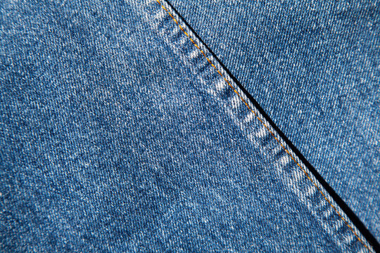 authentic original jeans texture background close up with characteristic structural joint