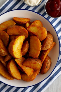 Homemade Potato Wedges with Ketchup and Mayonnaise, top view.