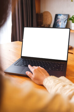 Vertical mockup image of a woman working on laptop computer with blank screen at home