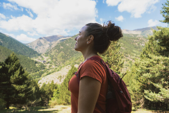 Woman hiking in mountains enjoying nature and freedom
