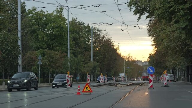 Cars driving on city boulevard during tram line roadworks