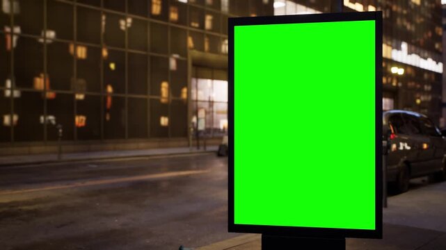Empty chroma key advertising panel standing on an urban avenue at dusk as the city lights come on, light fog. Cars rush by in a timelapse while the green screen stays sharp and ready for your design