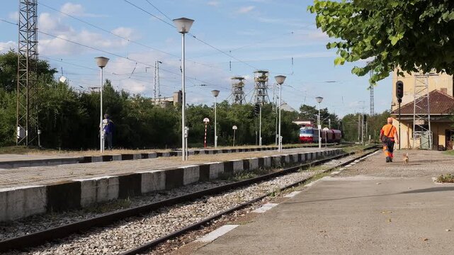 Railway worker walking along the platform at a train station