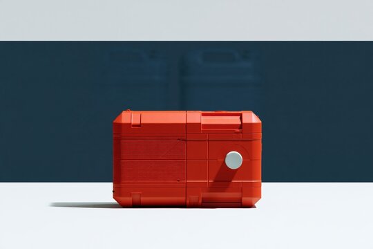 Red hand-crank radio with a textured finish on a dark blue background, a vivid survival tool for disaster risk reduction and preparedness
