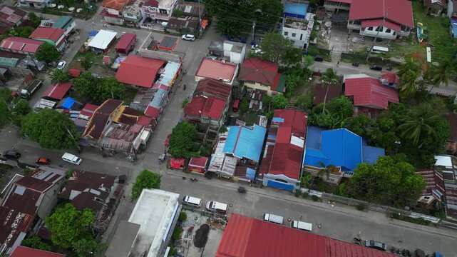 Aerial perspective of Ragay town in Camarines Sur, Philippines, with Andaya Park and the central municipal area leading toward Ragay Bridge, capturing the town's roads, buildings and surrounding tropi