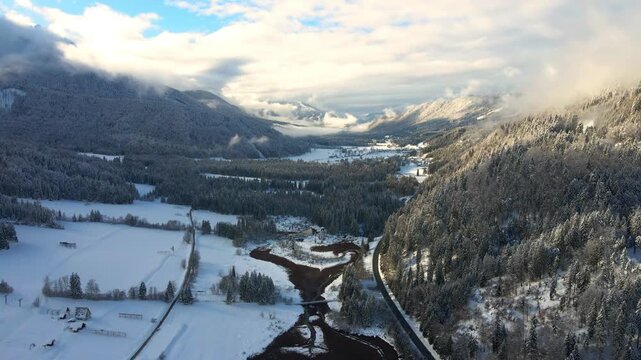 Drone gliding over the snow-covered Zelenci in Kranjska Gora Valley, Slovenia