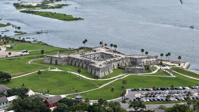 Aerial view of the historic Castillo de San Marcos fortress surrounded by green lawns and the Matanzas River in St. Augustine, Florida, United States.