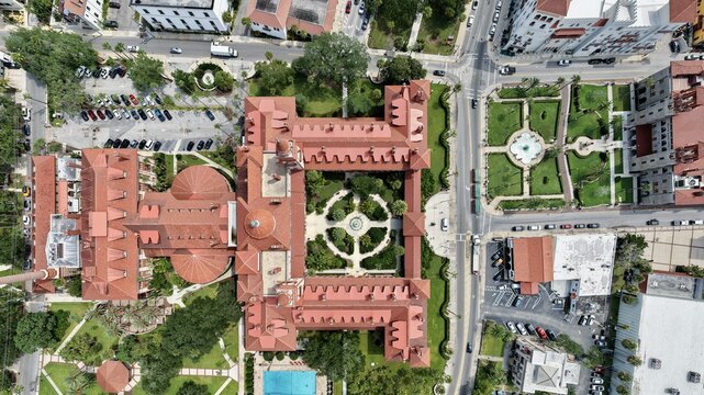 Aerial view of the historic Flagler College, formerly the Hotel Ponce de Leon, with its red-tiled roofs, central courtyard, and gardens in St. Augustine, Florida, United States.
