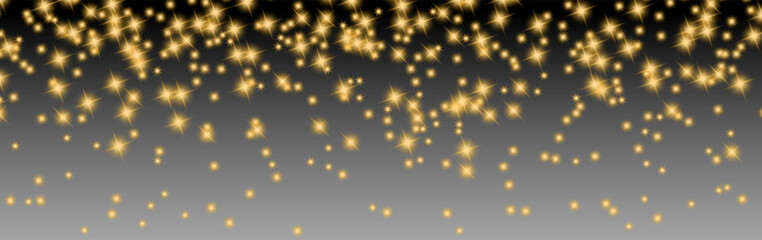 Obraz premium Glowing golden star sparkles scattered over a dark to gray gradient background, creating a festive luxury light effect for holiday designs