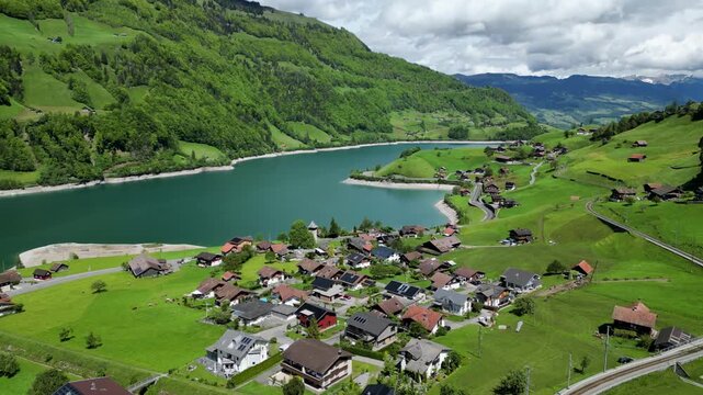 Aerial view of Lungern village, turquoise lake, and green alpine mountains in Switzerland in Lungern, Switzerland