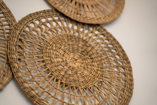 Close-up of round woven wicker wall baskets with natural texture